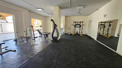 a room with a gym with tread machines and a chair at Boho Breeze Aheloy in Aheloy