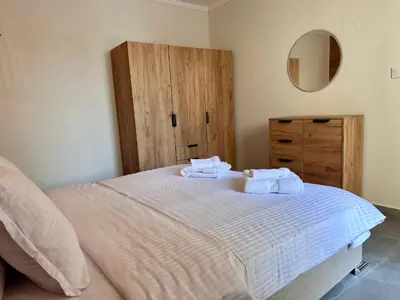 a bedroom with a bed with two towels on it at Casa Adora in Sozopol