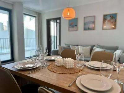 a wooden table with plates and wine glasses on it at Casa Adora in Sozopol