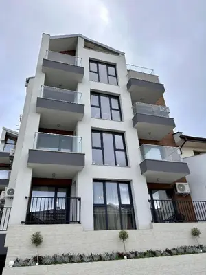 a tall white building with balconies on it at Casa Adora in Sozopol