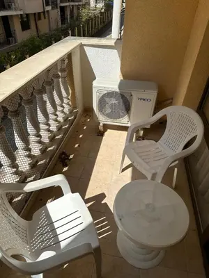 a balcony with a toilet and a table and chairs at 2 Room Apartment Royal Sun Sunnybeach in Sunny Beach