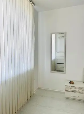 a room with a large sliding door and a mirror at Park suite in Burgas City