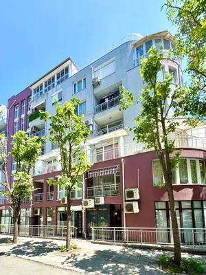 an apartment building with trees in front of it at Park suite in Burgas City