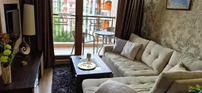 a living room with a couch and a table at Patrick's apartments - Harmony Palace in Sunny Beach