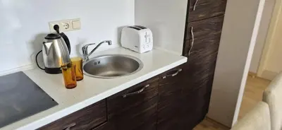 a kitchen with a sink and a toaster on a counter at Patrick's apartments - Harmony Palace in Sunny Beach