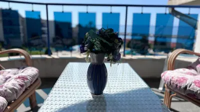 a vase filled with flowers sitting on a table at Relax in Riviera in Sveti Vlas