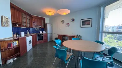 a kitchen with a table and chairs in a kitchen at Relax in Riviera in Sveti Vlas