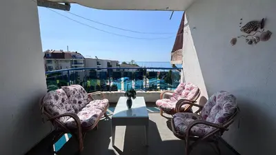 a balcony with chairs and a table and a view at Relax in Riviera in Sveti Vlas