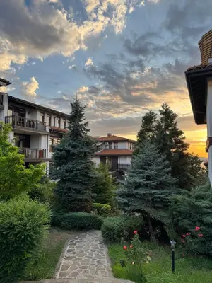 a group of trees in a yard with a pathway at Marena Studio - Santa Marina, Sozopol in Sozopol