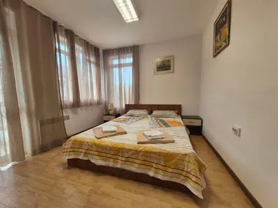 a bedroom with a bed with two towels on it at 2 Rooms Apartment - Top Center of Burgas in Burgas City