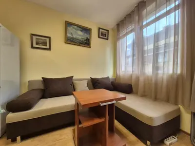 a couch in a living room with a window at 2 Rooms Apartment - Top Center of Burgas in Burgas City