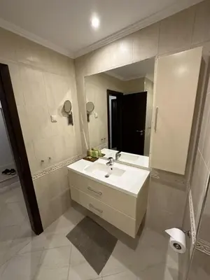 a bathroom with a sink and a large mirror at Oasis Beach Club - 