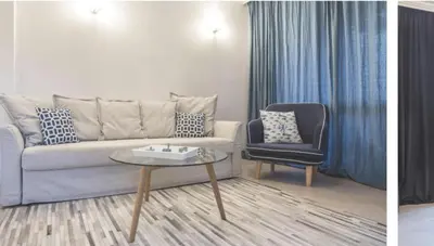 a living room with a couch and a chair at Oasis Beach Club - 