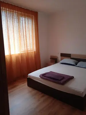 a bedroom with a large bed and a window at Тристаен апартамент в Бяла комплекс Атлантик in Byala