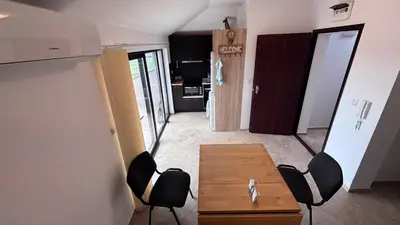 a living room with a wooden table and chairs at Relax in Kosharica in Kosharitsa