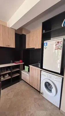 a kitchen with a washing machine in a room at Relax in Kosharica in Kosharitsa
