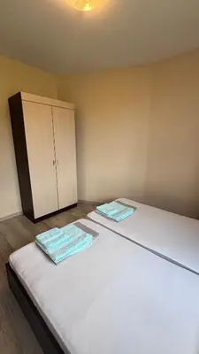 two beds in a room with a cabinet at Relax in Kosharica in Kosharitsa