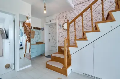 a staircase in a home with a brick wall at Sirena Seaview Apartment - FREE PARKING in Varna City