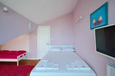 a bedroom with a bed and a flat screen tv at Sirena Seaview Apartment - FREE PARKING in Varna City