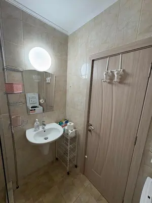 a bathroom with a sink and a mirror and a door at Ravda Apolon 9 Apartment in Ravda
