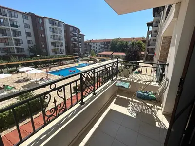 a balcony with a view of a swimming pool at Ravda Apolon 9 Apartment in Ravda