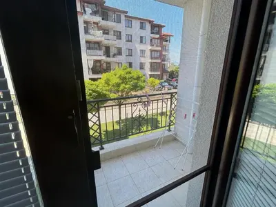 a door to a balcony with a view of a building at Ravda Apolon 9 Apartment in Ravda