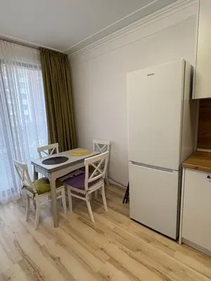 a kitchen with a table and a refrigerator at Ravda Apolon 9 Apartment in Ravda