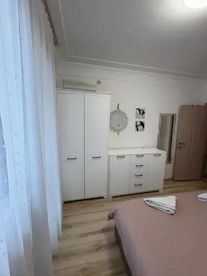 a bedroom with a bed and a dresser at Ravda Apolon 9 Apartment in Ravda