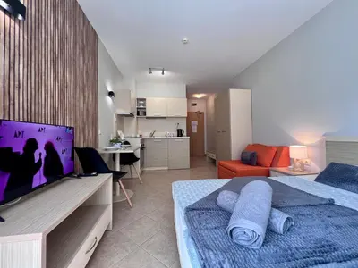 a bedroom with a bed and a living room at Apartament Royal Sun Romantic - 5 min to the beach in Sunny Beach