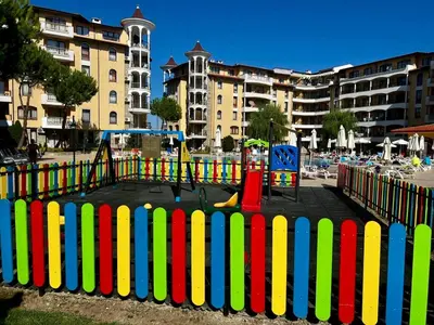 a colorful fence in front of a playground at Apartament Royal Sun Romantic - 5 min to the beach in Sunny Beach