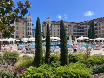 a resort with a pool and chairs and umbrellas at Apartament Royal Sun Romantic - 5 min to the beach in Sunny Beach