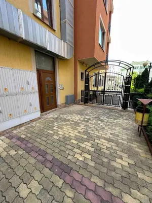 an open gate to a building with a patio at Свети Влас комплекс Викторио in Burgas City