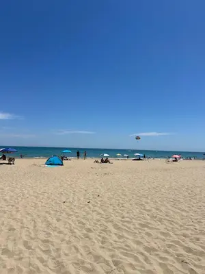 a group of people on a beach with umbrellas at 2 Zimmerwohnung in Shkorpilovtsi