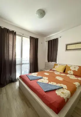 a bedroom with a large bed with a red blanket at Apartment 7 in Sozopol