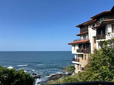 an apartment building on the side of the ocean at Saint Thomas Holiday Village Condo in Sozopol