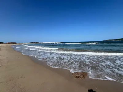 a sandy beach with the ocean on a clear day at Saint Thomas Holiday Village Condo in Sozopol