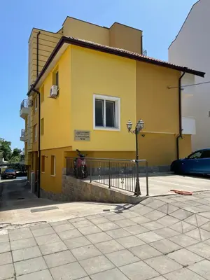 a yellow house with a fence in front of it at Sarafovo Summer 1 - Relaxing Apartment Near Beach in Sarafovo