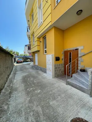a yellow building with stairs on the side at Sarafovo Summer 1 - Relaxing Apartment Near Beach in Sarafovo