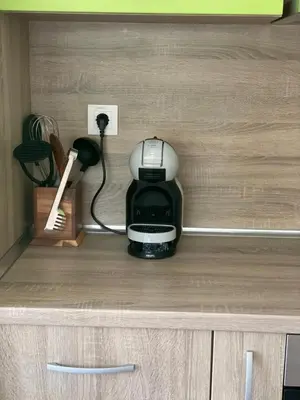 a coffee maker and a phone in a cabinet at Sarafovo Summer 1 - Relaxing Apartment Near Beach in Sarafovo