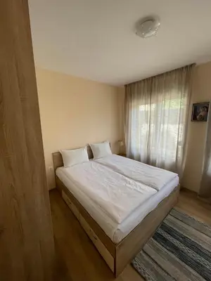 a bedroom with a bed with white sheets and a window at Sarafovo Summer 1 - Relaxing Apartment Near Beach in Sarafovo