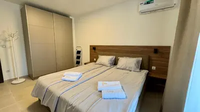 a bedroom with a bed with two towels on it at Emperium 1 Apartments Sveti Vlas in Sveti Vlas