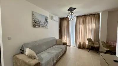 a living room with a couch and a dining room at Emperium 1 Apartments Sveti Vlas in Sveti Vlas