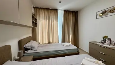 a hotel room with a bed and a window at Emperium 1 Apartments Sveti Vlas in Sveti Vlas