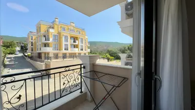 a balcony with a view of a yellow building at Emperium 1 Apartments Sveti Vlas in Sveti Vlas