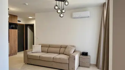 a living room with a couch in a room at Emperium 1 Apartments Sveti Vlas in Sveti Vlas