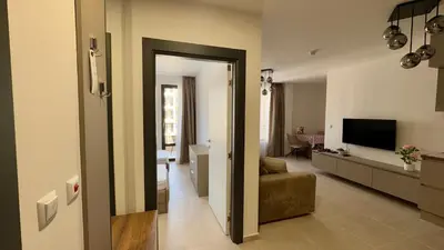 a living room with a couch and a television at Emperium 1 Apartments Sveti Vlas in Sveti Vlas