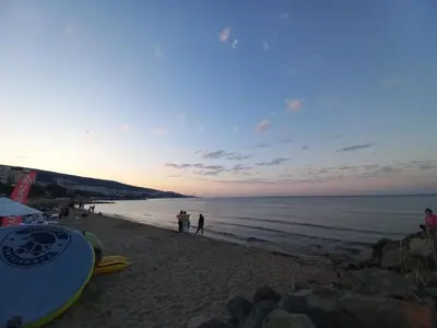 a group of people standing on a beach at Cozy studio 150m from the beach in Sveti Vlas