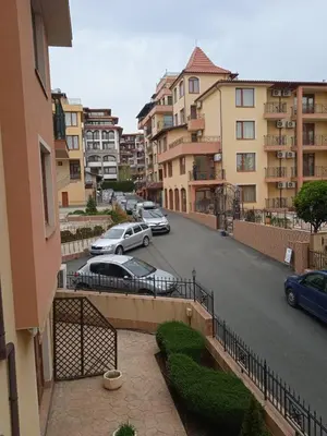 a view of a street with cars parked in a parking lot at Cozy studio 150m from the beach in Sveti Vlas
