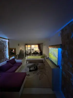 a living room with a couch and a flat screen tv at Sea view apartment in Sozopol