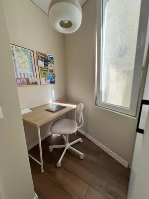 a small desk with a chair and a window at Lazur Beach Residence - 10min walk to beach in Burgas City